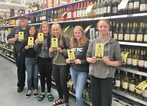 Students pose with Bottle Tags at Walmart.